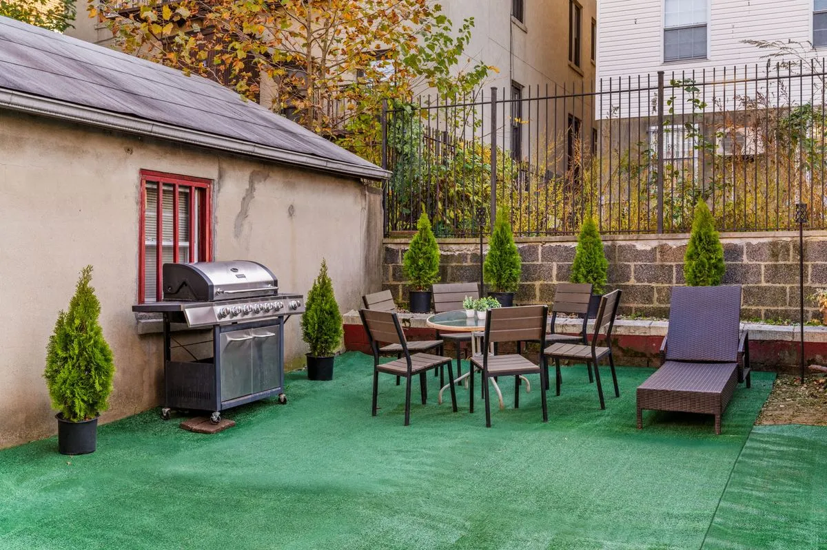 Private backyard with barbecue grill, dining table, and lounger