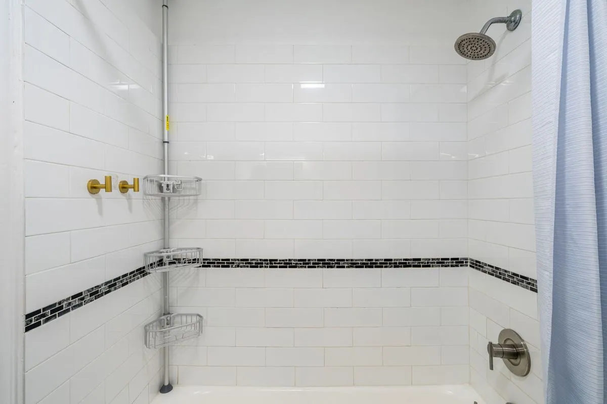Subway-tiled tub and shower with rainfall showerhead
